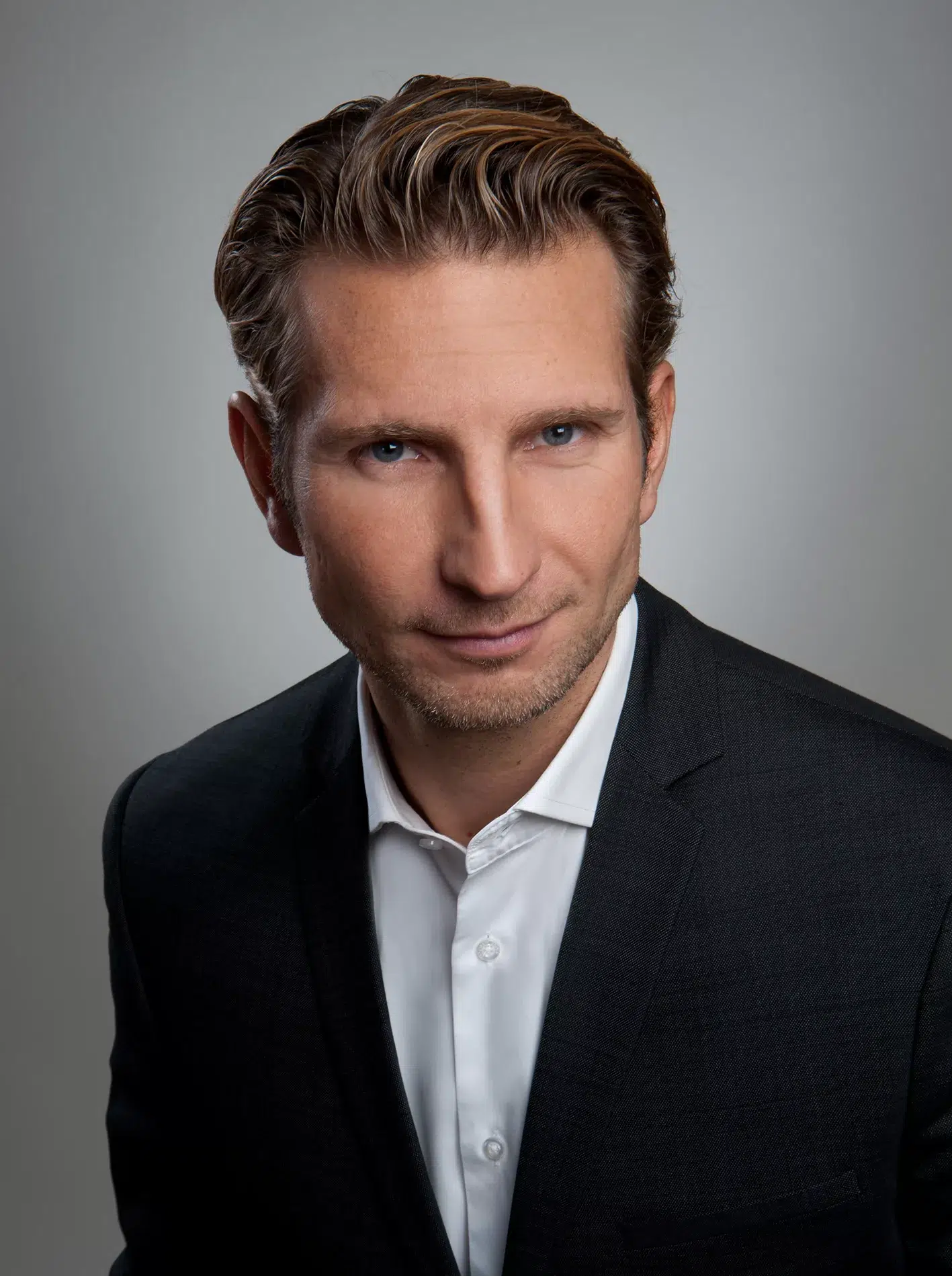 Ein eleganter Mann in Anzu steht für ein Foto bereit